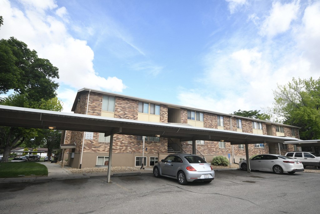 a parking lot with cars in front of a building