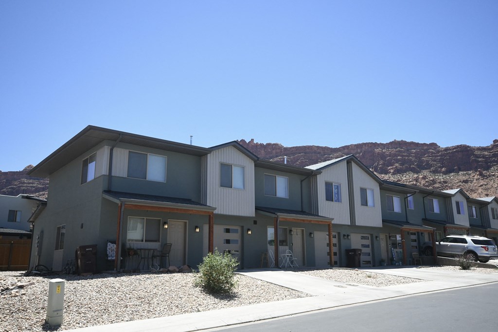 a row of houses with mountains in the background