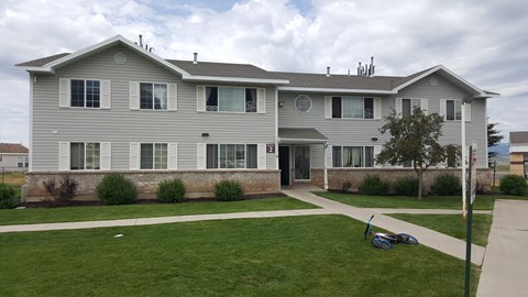 a white house with a bike parked in the yard