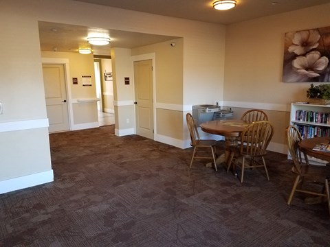 a dining room with a table and chairs and a book shelf