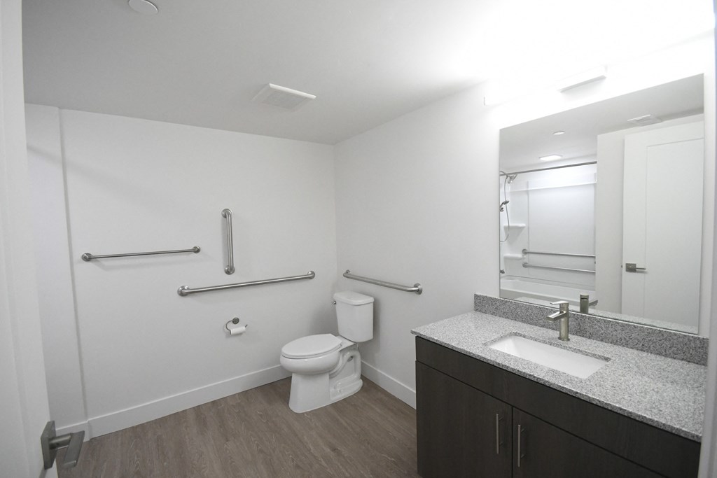 a bathroom with a toilet and a sink and a mirror