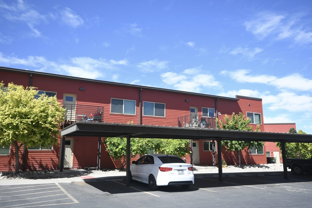 a car parked in front of a red building