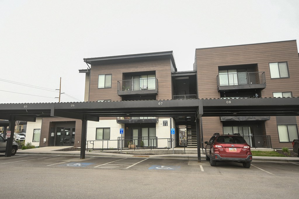 a red car parked in front of a building