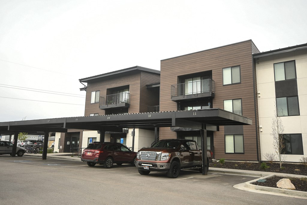 a parking lot with cars in front of a building