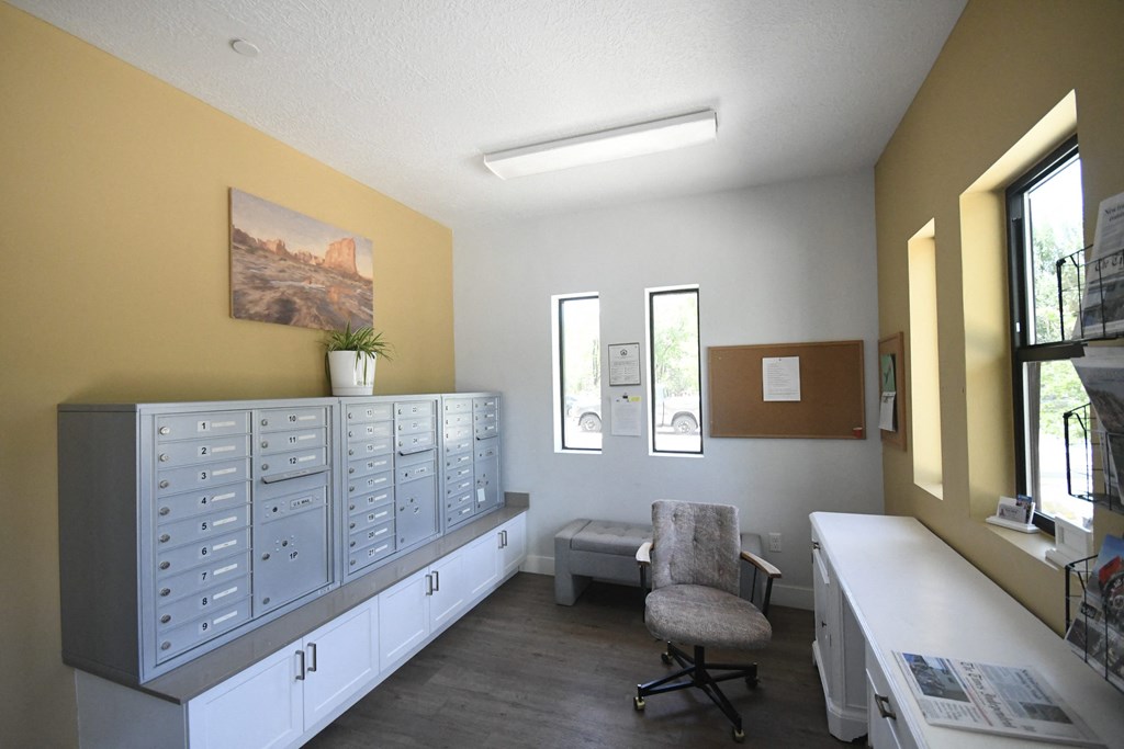 an office with white cabinets and a chair and a desk