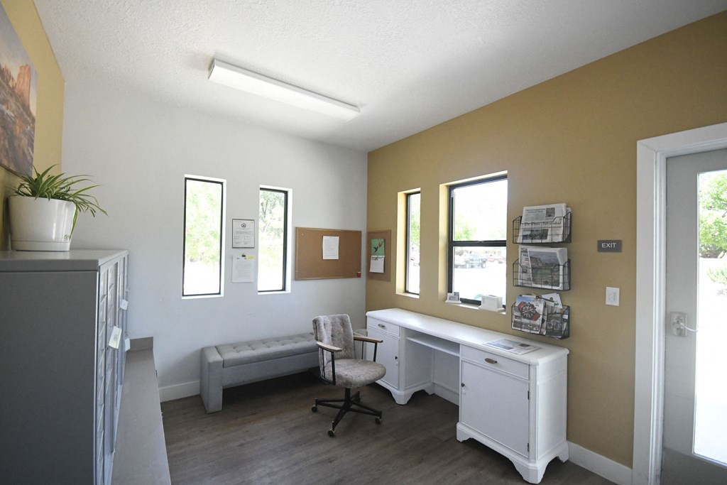 an office with a desk and a chair and a window