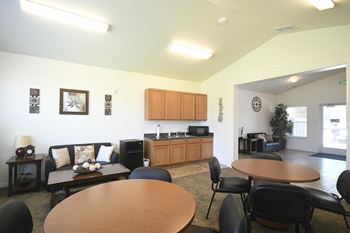 a living room with a dining room table and a kitchen