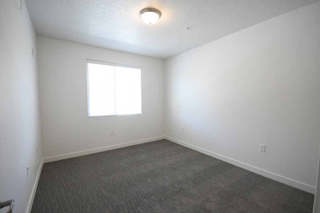 a room with a floor and a window and a light on the ceiling