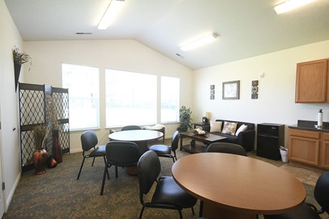 a dining room with tables and chairs and a large window
