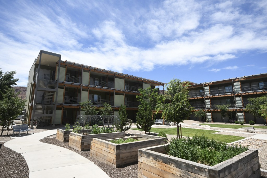 the courtyard of an apartment building with trees and plants
