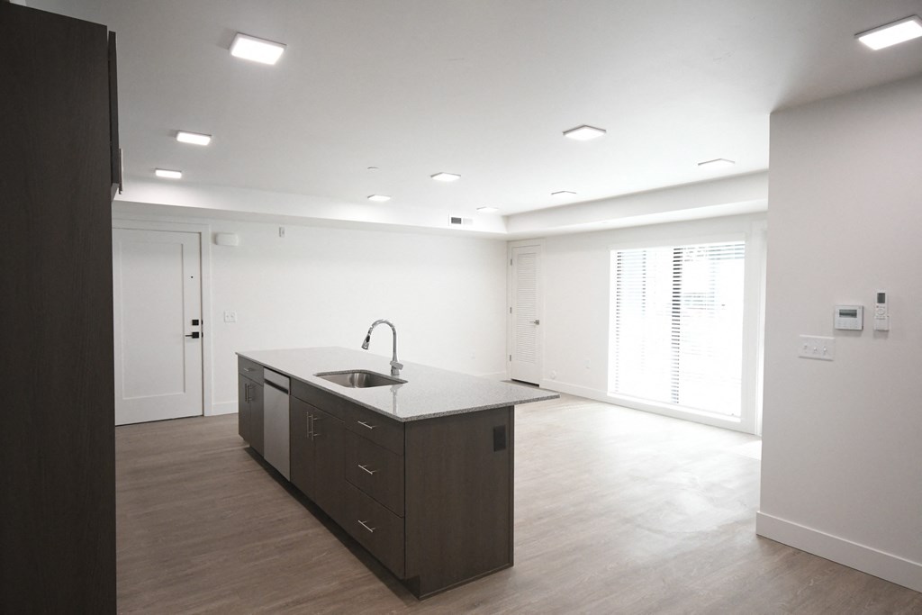 an empty kitchen and living room in a new home