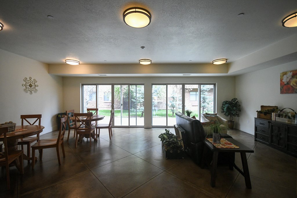 an open living room and dining room with sliding glass doors