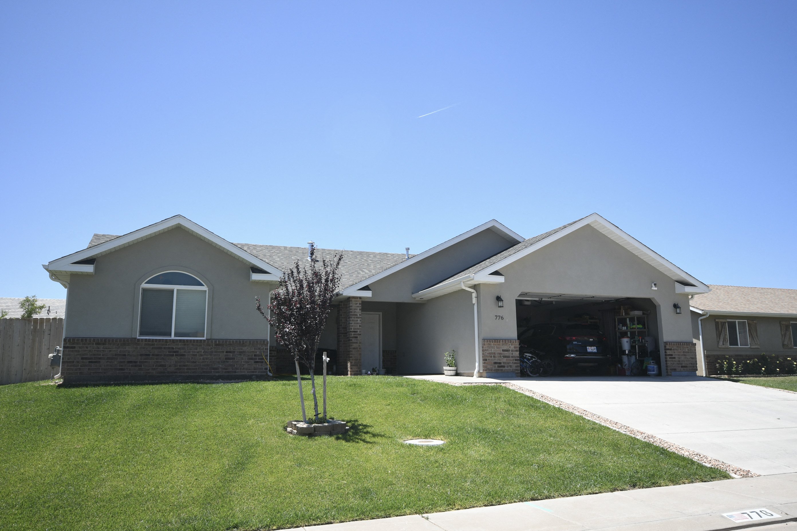 a house with a driveway and a lawn in front of it