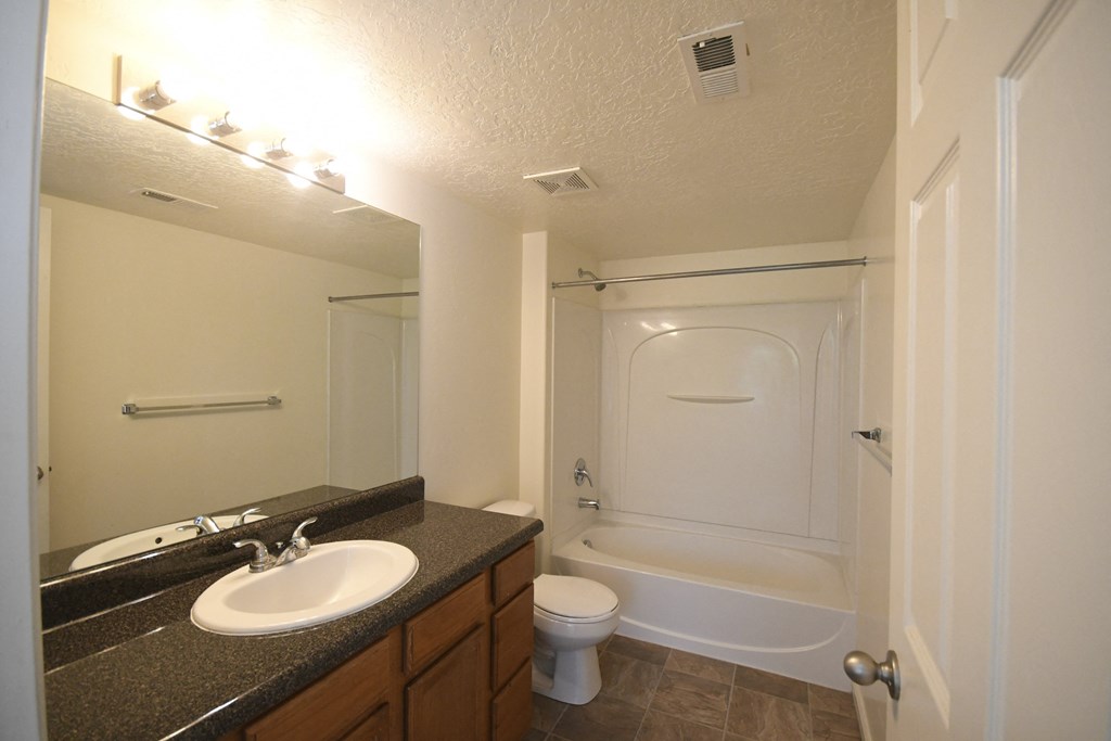 a bathroom with a sink and a toilet and a shower
