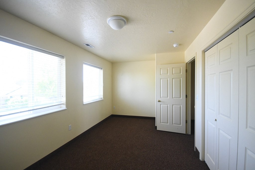 an empty room with a door and a window
