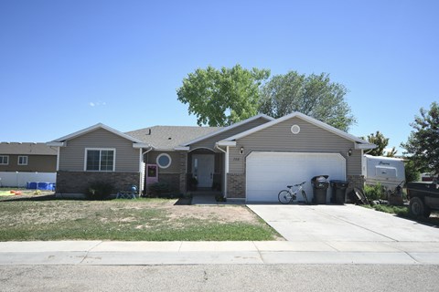 a house with a garage and a bike parked in the driveway