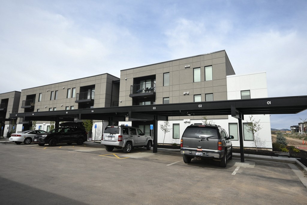 a parking lot with cars parked in front of a building