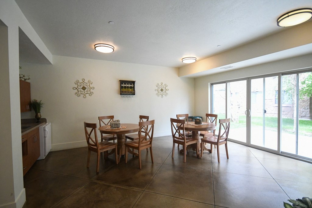 a dining room with a table and chairs and sliding glass doors