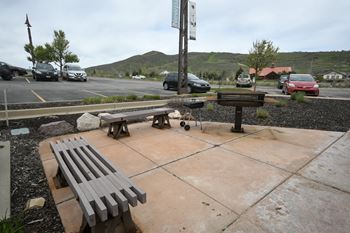 a picnic table and bench in a parking lot