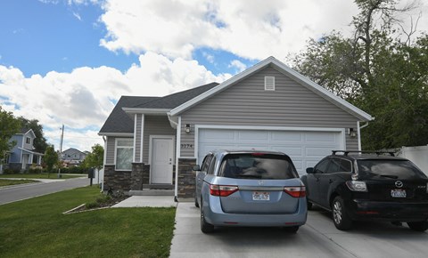 a house with two cars parked in front of it