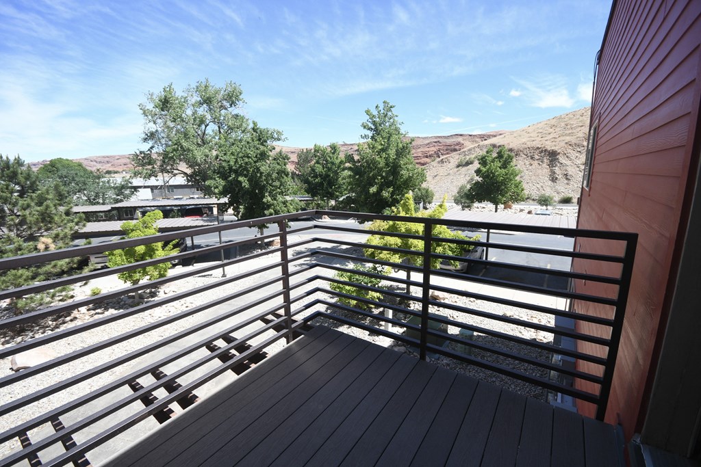 a view from the balcony of a house with a mountain in the background