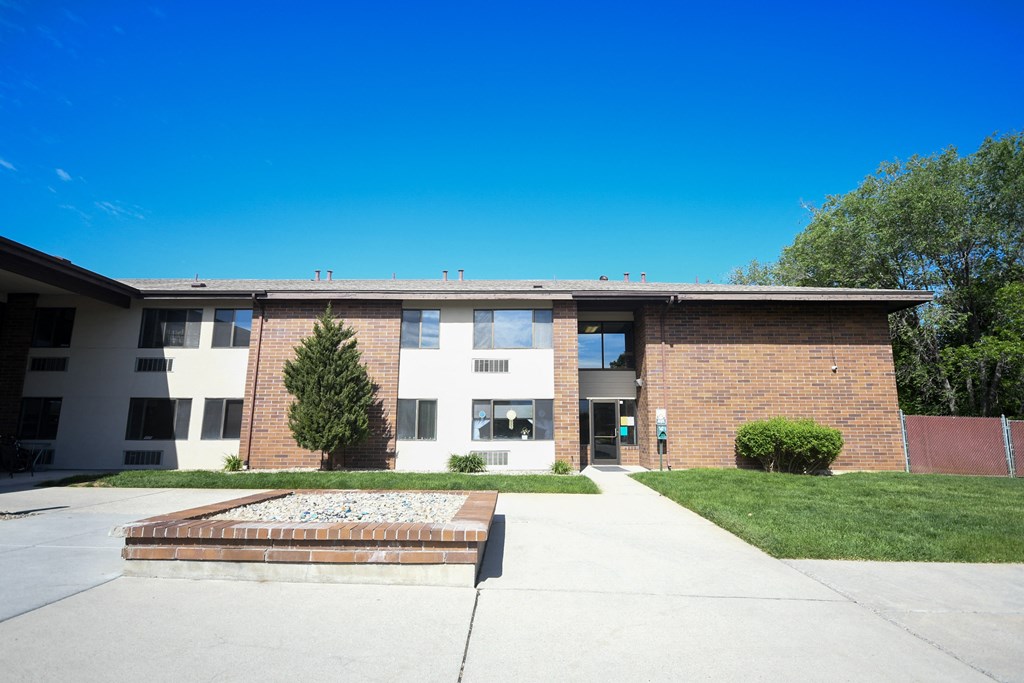 a brick building with a sidewalk in front of it