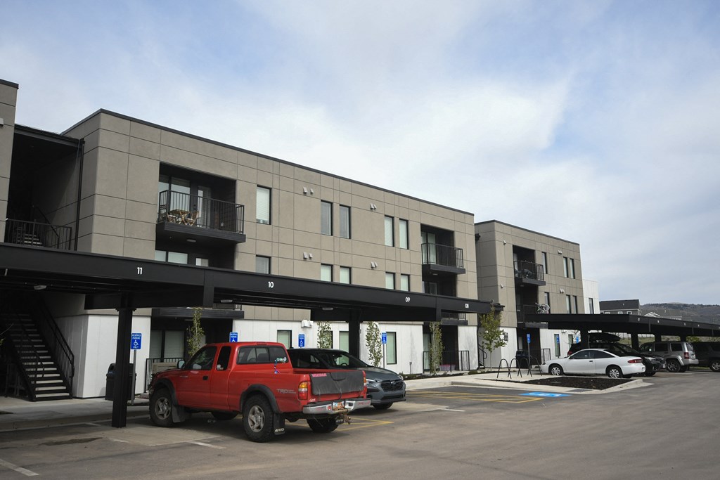 a parking lot with cars in front of a building