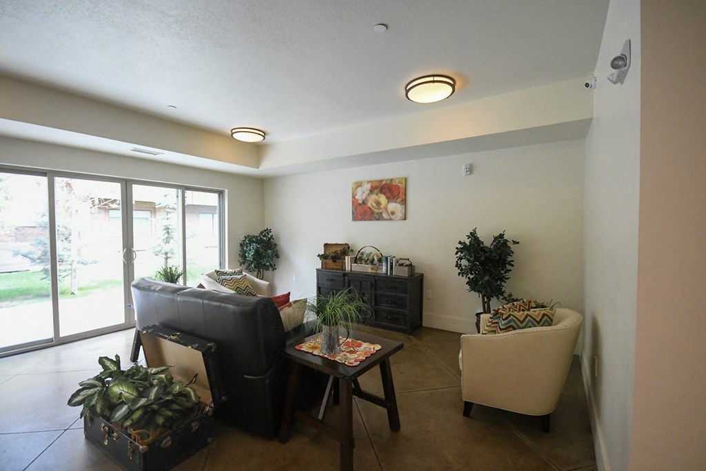 a living room with a couch and chairs and a table