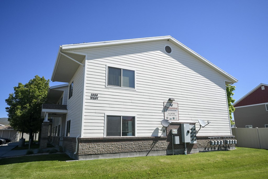 a white house with a satellite dish on the side of it