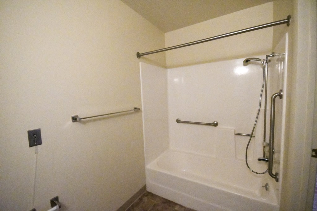 a bathroom with a shower and a tub and a shower curtain
