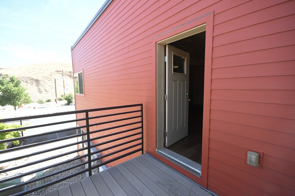 the front door is open to the balcony