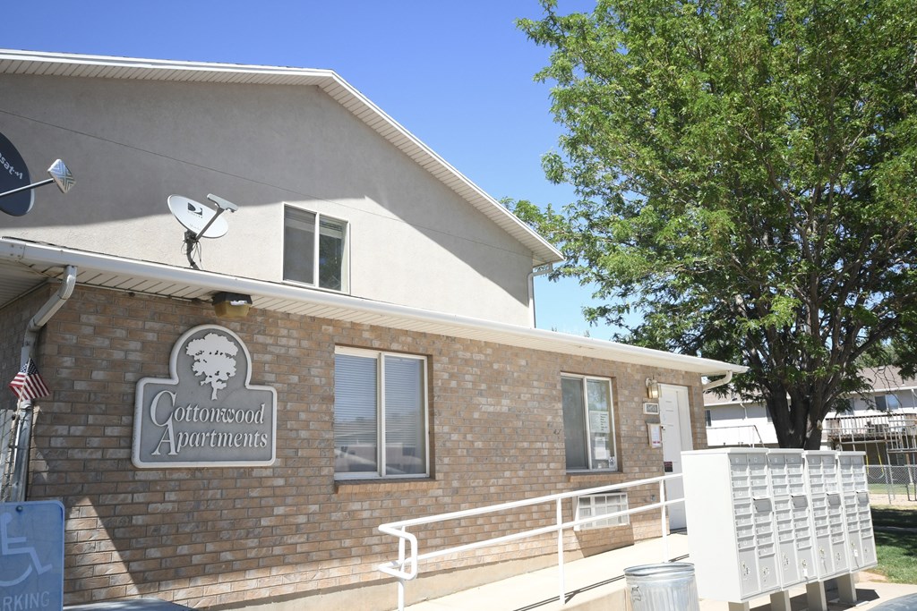 a brick building with a satellite dish on the side of it