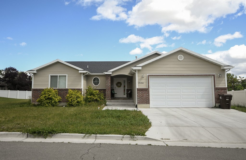 a tan house with a white garage door