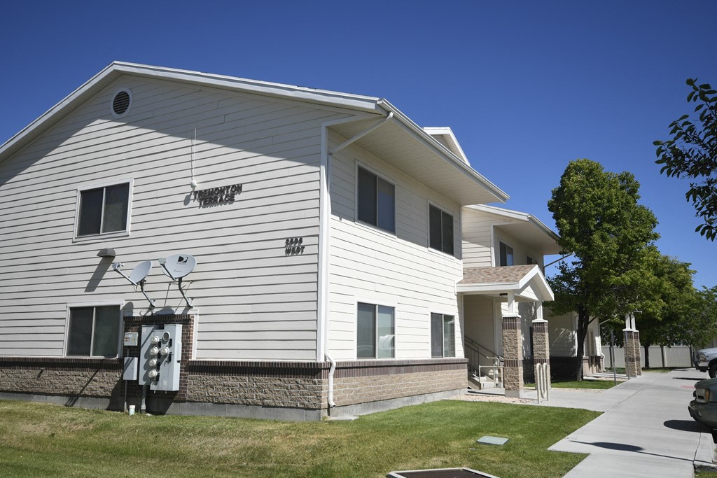 a white house with a basketball hoop on the side of it