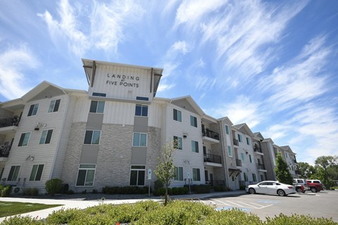 an apartment building with a large sign that reads laughing fire points