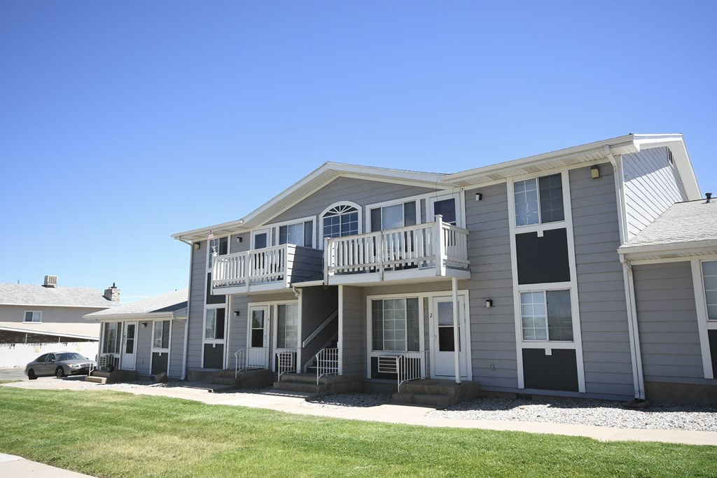 the exterior of a house with a car parked in front of it