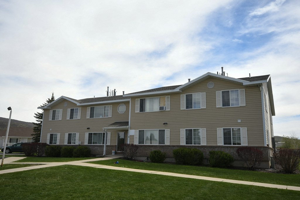 a large house with a sidewalk in front of it