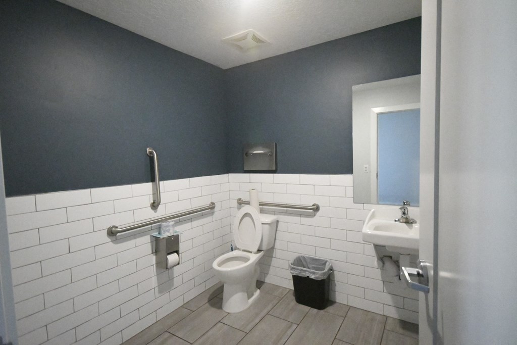a public bathroom with a toilet and a sink
