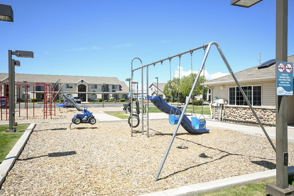 a childrens playground with a chain link fence with the word play in the foreground