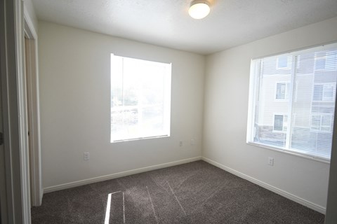 an empty room with carpet and a window