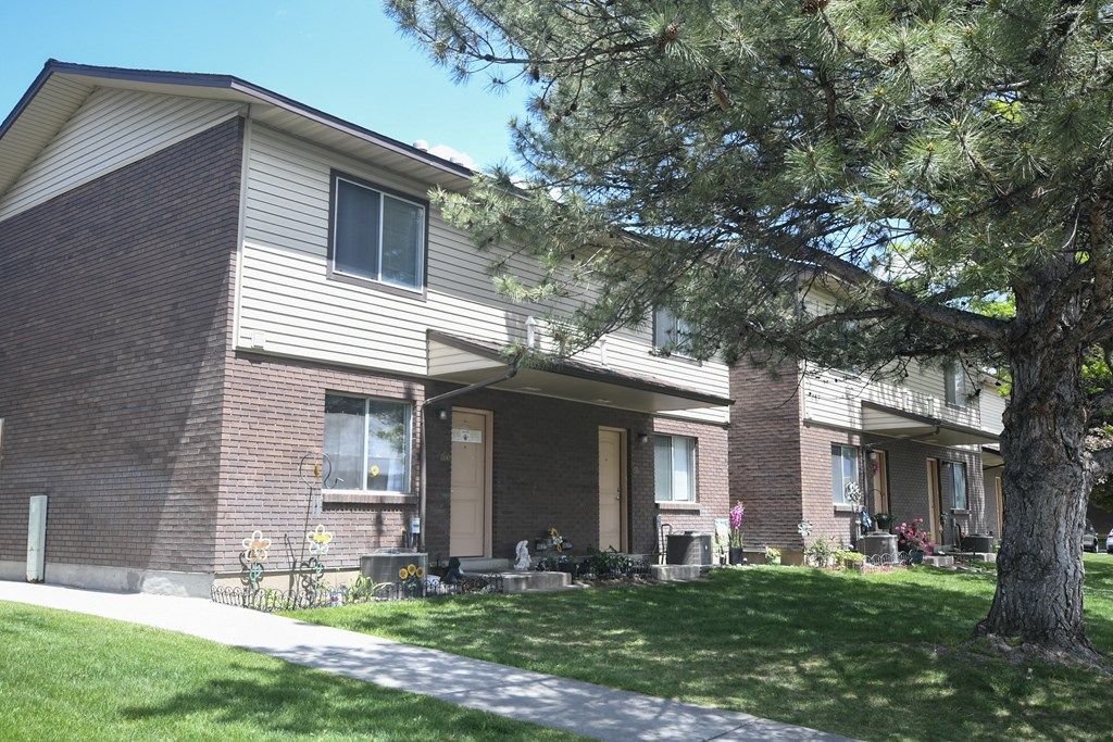 a brick house with a tree in front of it