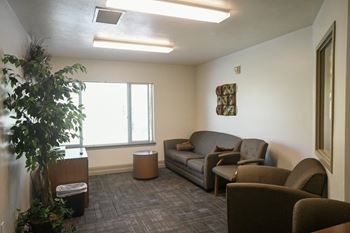 a living room with couches and chairs and a window