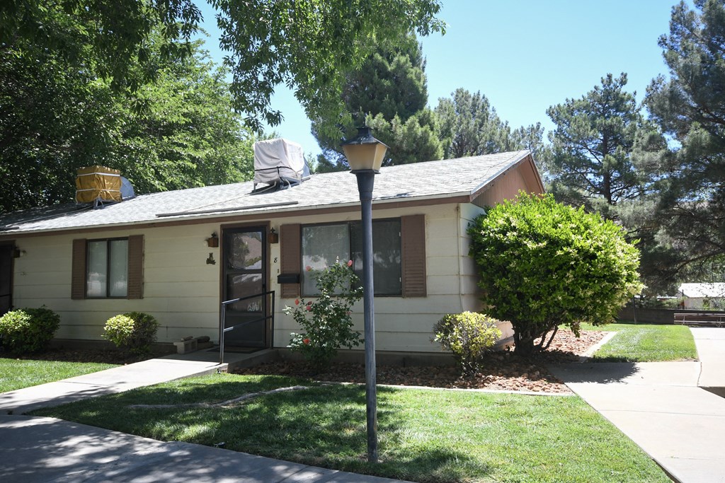 a white house with a lamp post in front of it