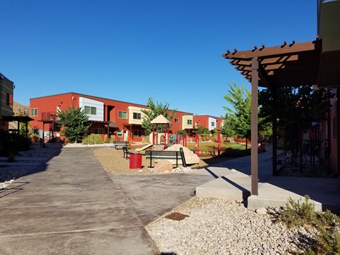 an empty playground in front of an apartment building