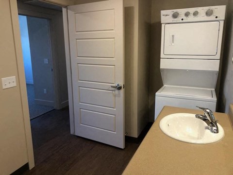 a kitchen with a sink and a stove and a refrigerator