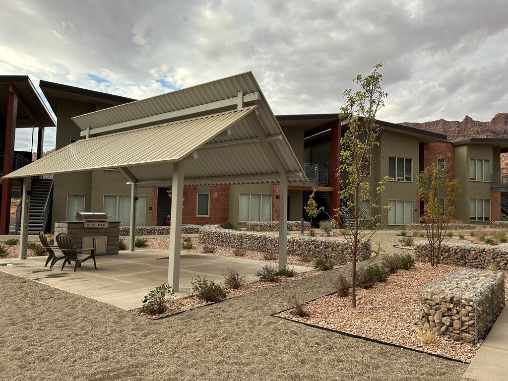 A building with a covered patio area in front of it.