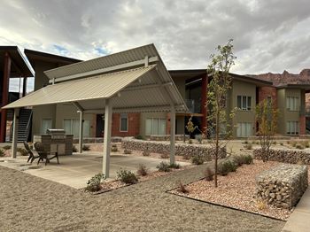 A building with a covered patio area in front of it.