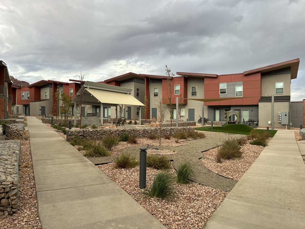 A modern building with a landscaped front yard.