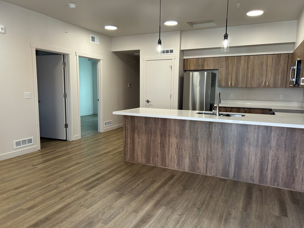 A kitchen with a wooden counter and stainless steel appliances.