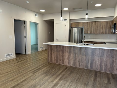 A kitchen with a wooden counter and stainless steel appliances.